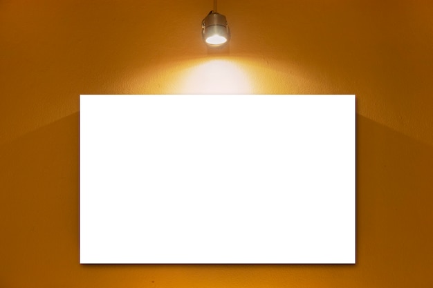 White blank board on wall with lamp.