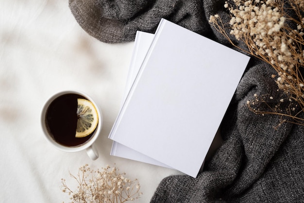 White blank books with gray plaid cup of lemon tea and dry flowers mockup design