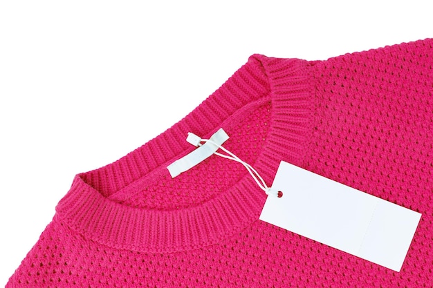 White blank rectangular clothing tag on pink knitted sweater isolated on white background