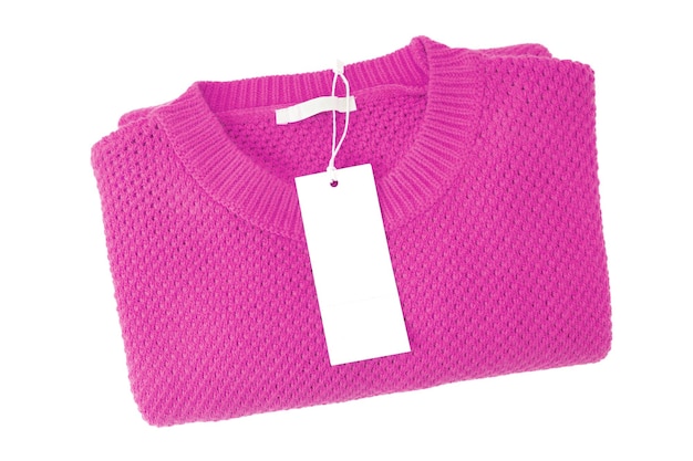 White blank rectangular clothing tag on pink knitted sweater isolated on white background