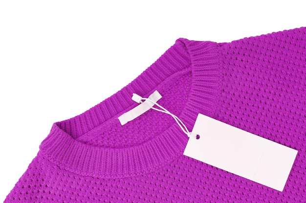 White blank rectangular clothing tag on purple knitted sweater isolated on white background