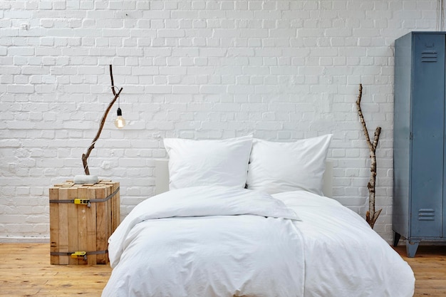 White blanket on bed against wall at home