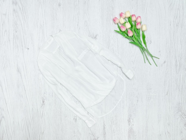 White blouse and a bouquet of tulips