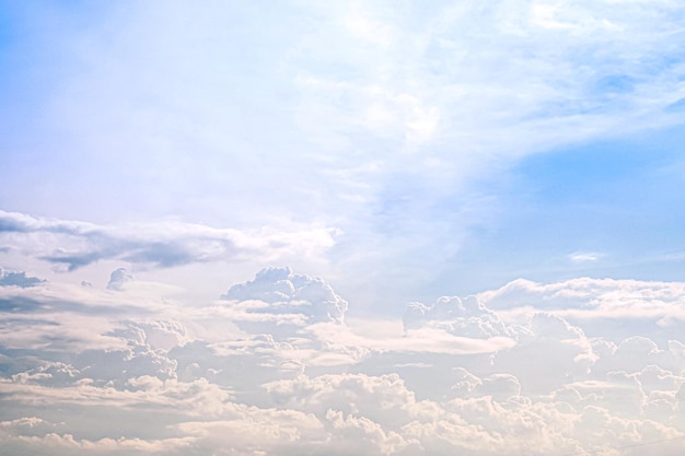 White blue soft cumulus clouds in the sky close up backgroun