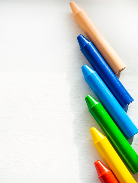 White board with colored crayons for drawing Space for copying The concept of the day of knowledge September 1 the beginning of classes