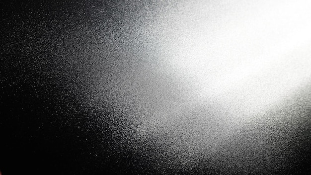 White bokeh and beam on a black background Blurred glow from above on a dark surface Night or space theme Bokeh for the holiday Abstract background Glare ray and light shine from above