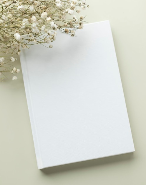 White book blank cover mockup on a beige background with dry flower flat lay mockup