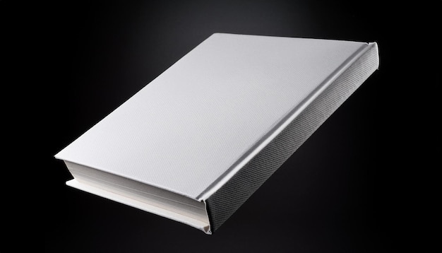 a white book with a silver edge is shown against a black background