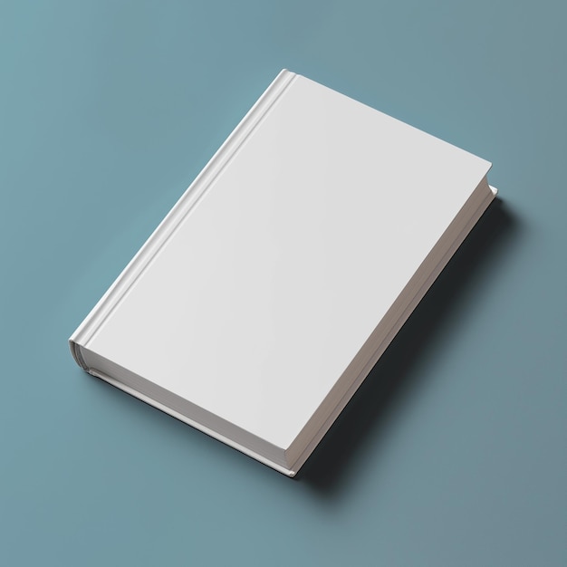 a white book with a white cover is laying on a blue table