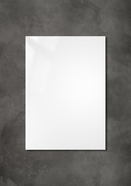 White booklet cover isolated on dark concrete surface,