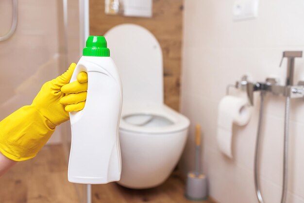 White bottle mockup for toilet sanitizer Closeup hand holding bottle of liquid