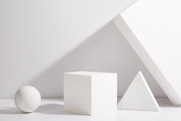 A white box with a triangle on it is next to a white egg Background for product display