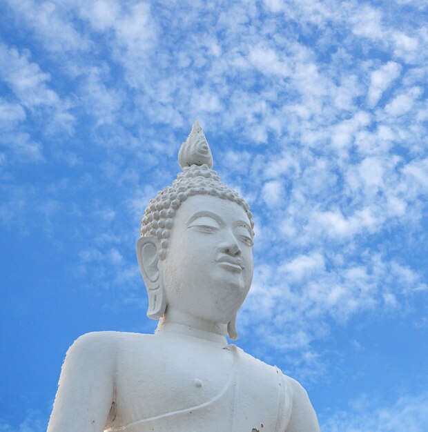 White Buddha statue and blue sky