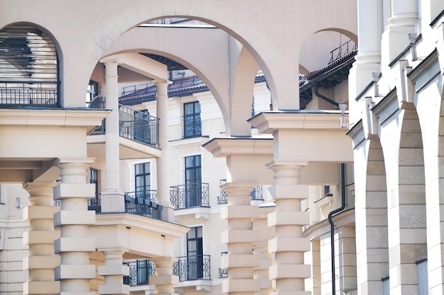 white building with beautiful unusual columns and balconies with black bars