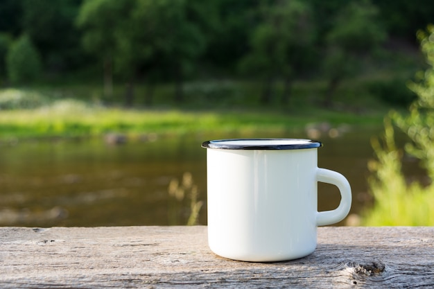 White campfire enamel mug river view