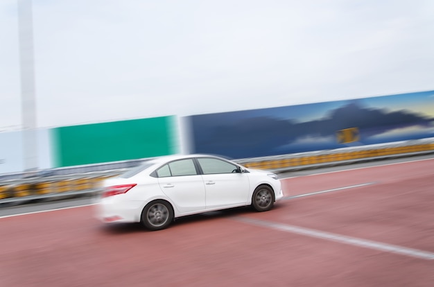 White car speed running on the road.motion picture blurred.