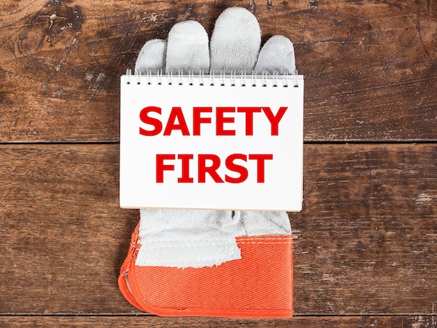 Photo white card in safety glove on wooden