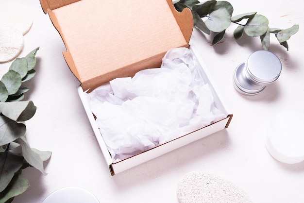 White cardboard carton box decorated with Eucalyptus green branc