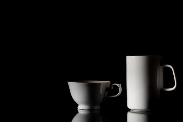 White ceramic coffee cup in the dark.