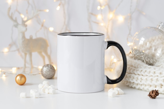 White ceramic coffee cup with black handle mockup with winter xmas decorations and copy space for