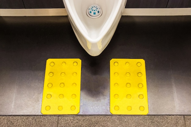 White ceramic urinals in men's bathroom design for the visually impaired. Japan