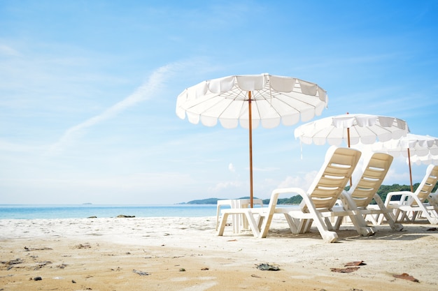 White chair with sun umbrella in the beach on seafront 