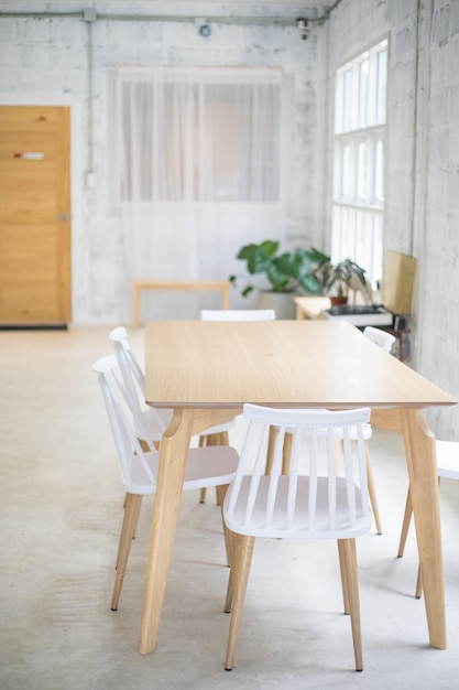 White chairs and wooden table at the room