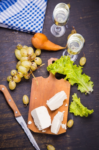 White cheese, grape and lettuce with white wine