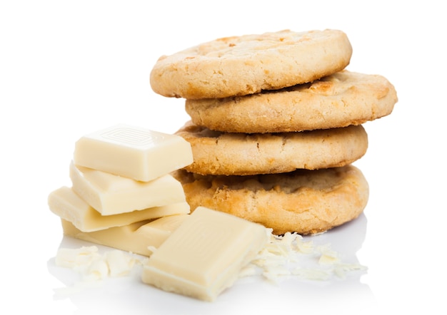 White chocolate biscuit cookies with chocolate blocks and curls isolated