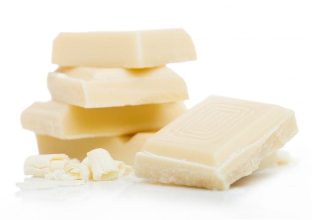 White chocolate pieces and curls isolated on white.