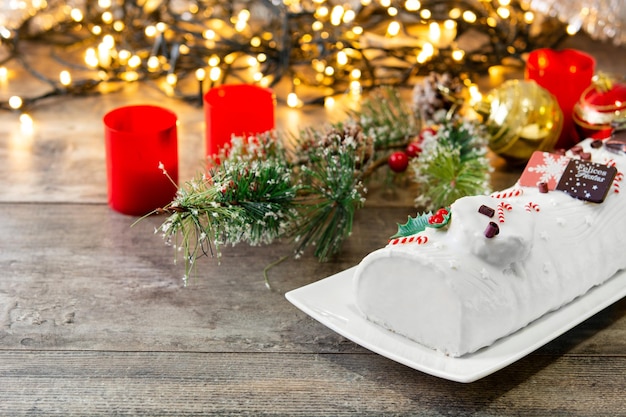 White chocolate yule log cake with ornament