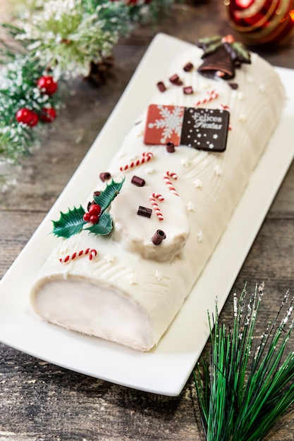 White chocolate yule log cake with ornament