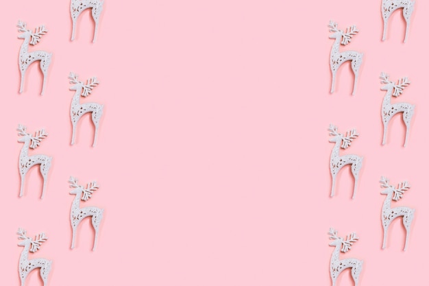 white christmas deer decoration on pastel pink background. Christmas concept.