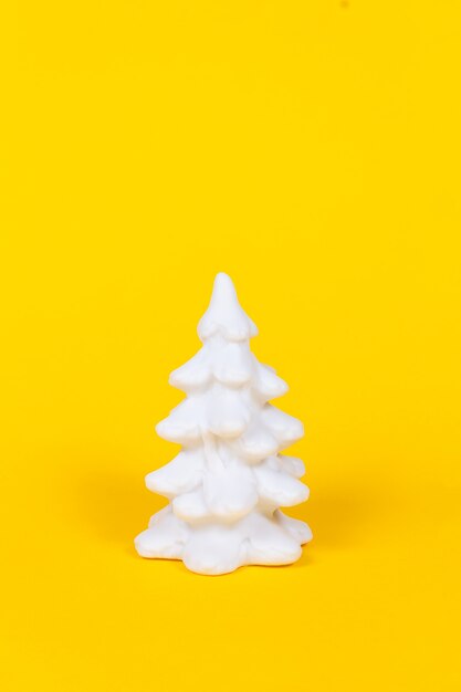 White christmas tree on vivid yellow background.