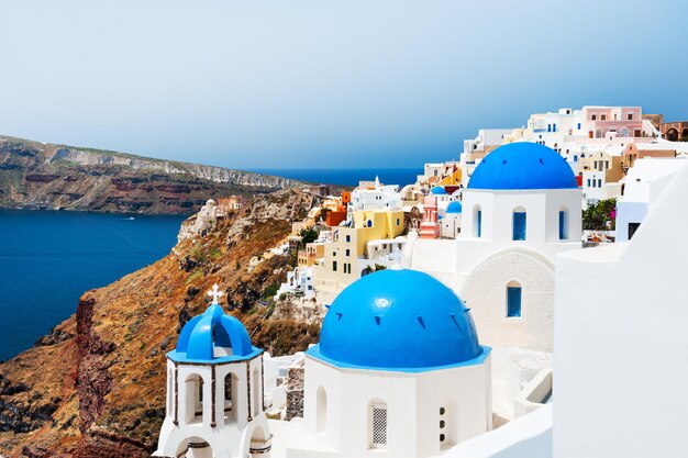 White church with blue domes on Santorini island, Greece. Beautiful landscape, sea view