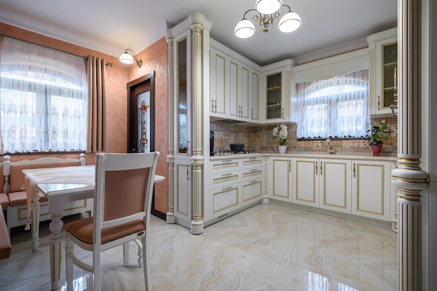 White classic cozy kitchen and dining room in city house