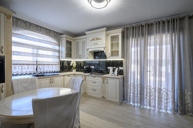 White classic cozy kitchen and dining room in city house