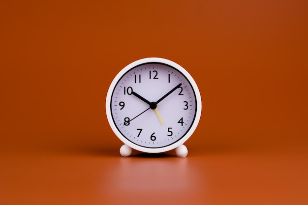 White clock on brown background time concept working with time Planning time for life