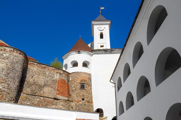 White clock tower of an ancient castle