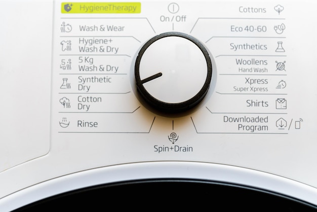 Photo white clothes dryer washing machine dial control panel with rotation knob and various program names in dutch