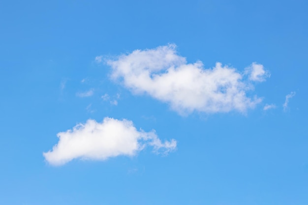 White clouds against a clear blue sky warm summer day