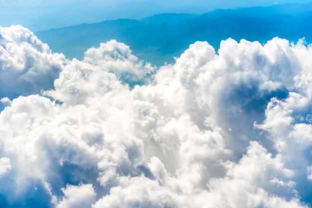 White clouds on blue sky with above aerial view from a plane nature blue sky background