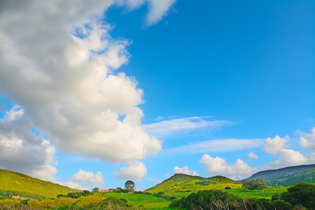 White clouds over a green landscape in Sardinia Italy