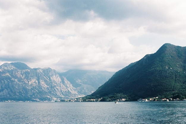 White clouds over green mountains in the bay of kotor