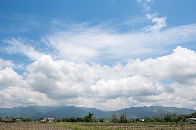 The white clouds have a strange shape and country side