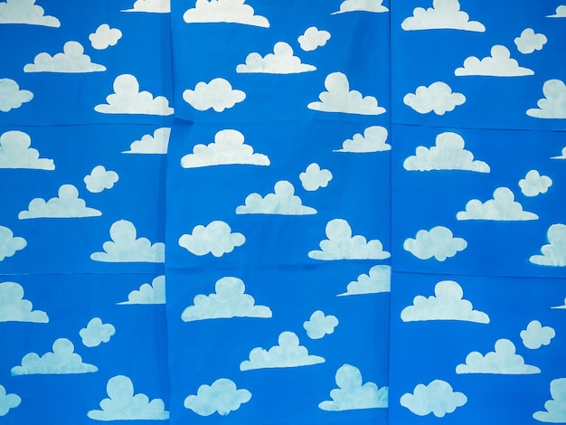 White clouds painting simple style on blue paper