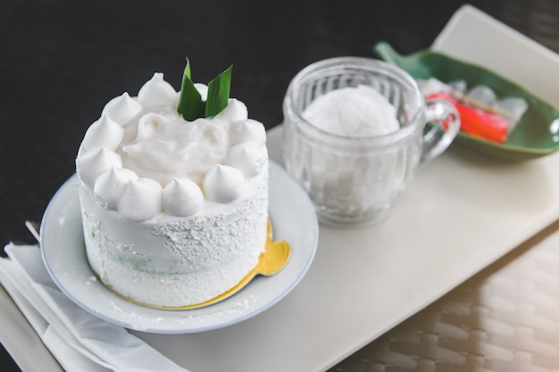 White coconut cake set with indoor lighting