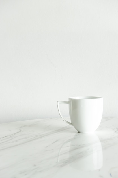 white coffee cup on marble table