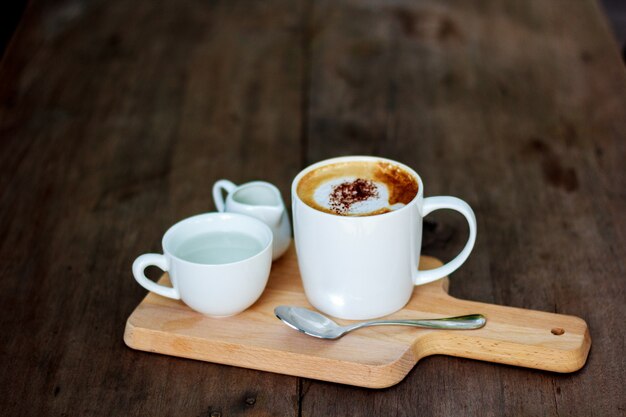 White coffee cup placed on wood.