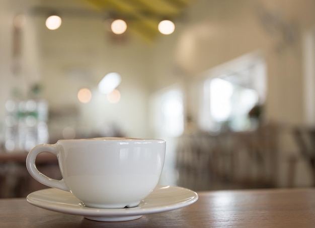 White coffee cup on table in shop